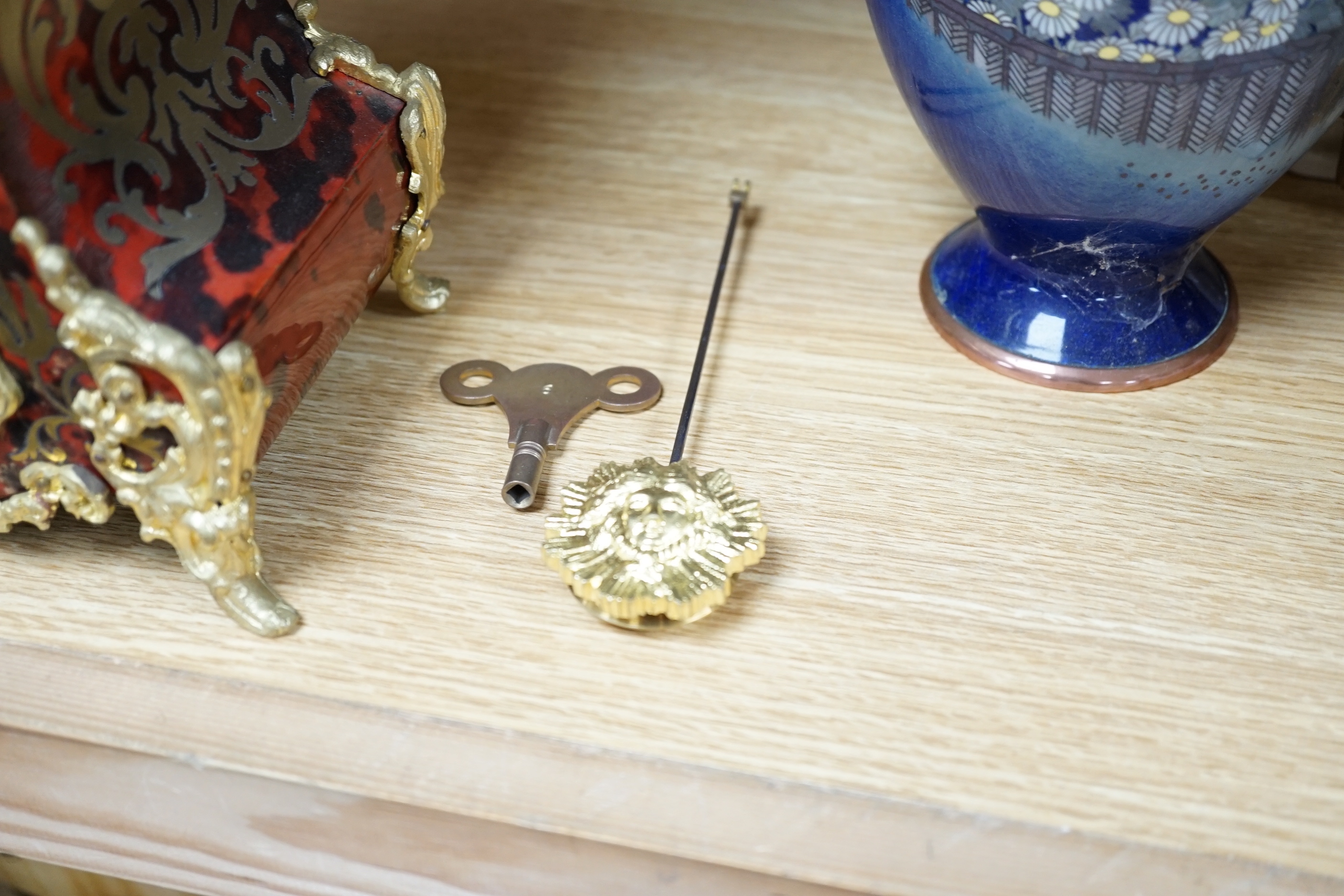 A French red boulle mantel clock, with French movement, striking on a coiled gong, height, 36cm